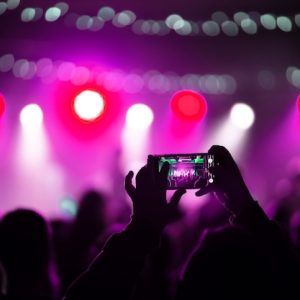 close-up-recording-video-with-smartphone-during-concert_1153-7310
